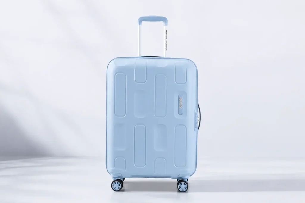 360° suitcase showcase with sleek angles Safari vs American Tourister Which is Better Warranty cards on a white backdrop Minimalist blue suitcase with logo